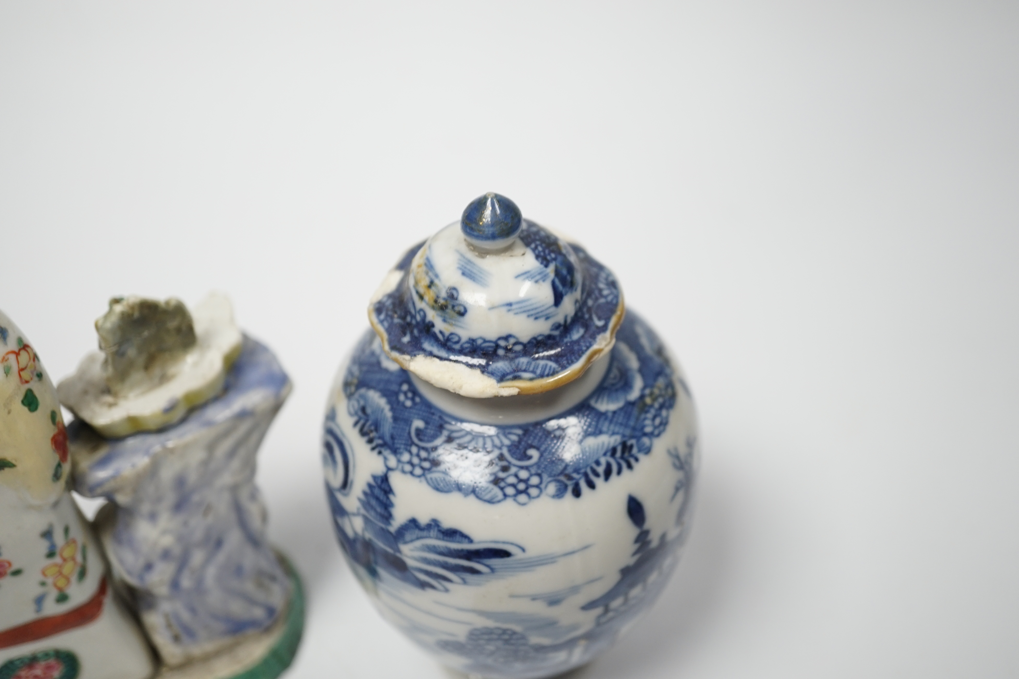 An 18th century Chinese enamelled porcelain figure of a lady standing by rockwork, a similar miniature vase and a blue and white tea caddy and cover, largest 17cm high